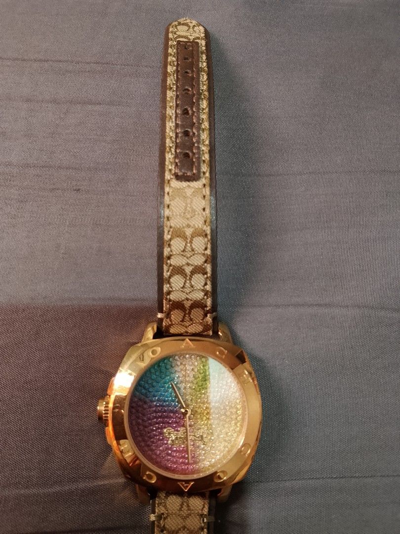 Coach Watch Rainbow Dial Monogram Strap (Category: Women's Watches) located in Manila. Submitted by wildwind_73f77a (Listing ID 1461507099, Image 3). Description: - Gold-tone Coach watch - Colorful rainbow-sparkle dial - Classic Coach monogram strap - Water resistant up to 3 ATM - Comes with original box - Perfect for adding a pop of color to any outfit.