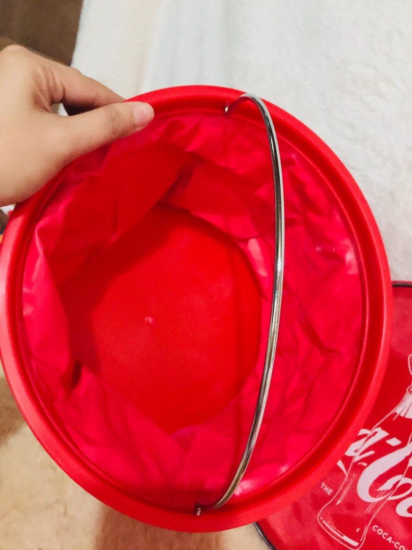 Coca-Cola 100 Years Bucket & Round Bag Set (Category: Cross-body Bags) located in Baguio. Submitted by izza_thrifty (Listing ID 1462063117, Image 2). Description: - Set includes a red Coca-Cola bucket and a round Coca-Cola bag. - Bucket is collapsible for easy storage. - Round bag features a secure zipper closure. - Both items showcase the iconic Coca-Cola logo and bottle design. - Ideal for Coca-Cola collectors or as a unique storage solution..