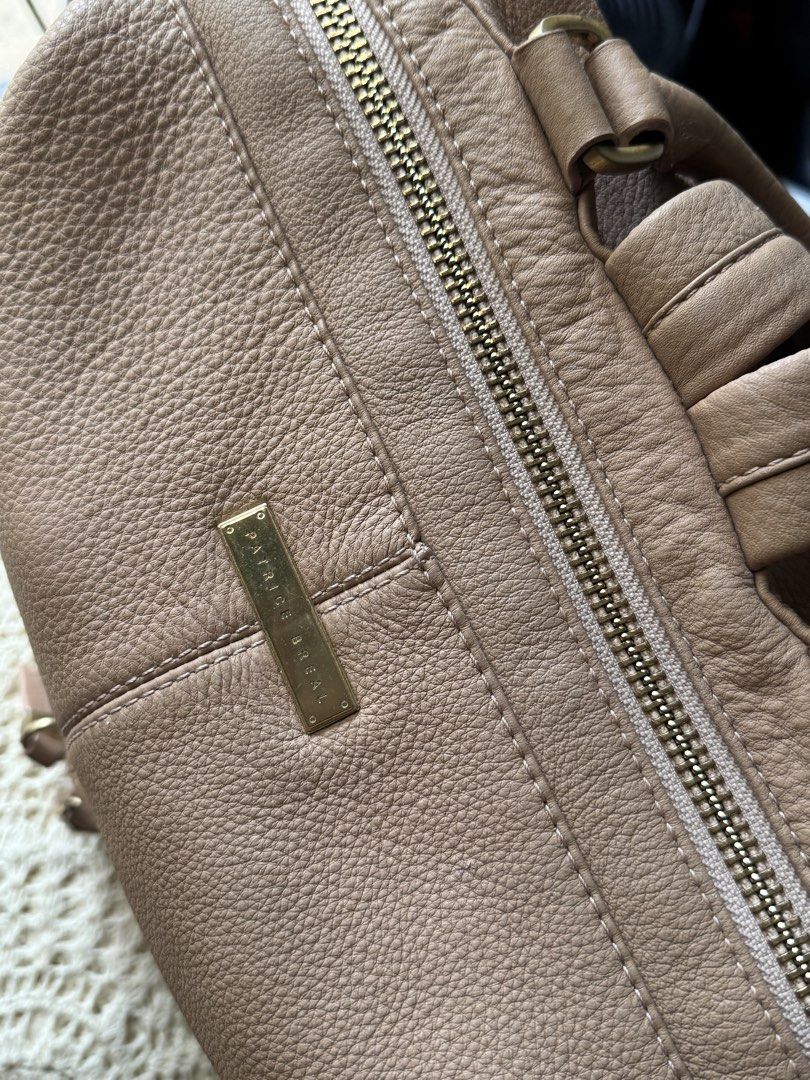 Convertible Leather Backpack. (Category: Backpacks) located in Bacolod City. Submitted by vintage_vogue6100 (Listing ID 1462139321, Image 2). Description: - Genuine tan leather backpack by P.B. - Main zippered compartment for secure storage - Additional front zippered pocket for quick access - Adjustable straps for a customized, comfortable fit - Elegant gold hardware details - Ideal for everyday use or travel adventures - Spacious interior to ho