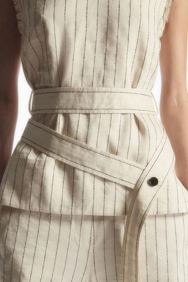 COS Striped Sleeveless Belted Top (Category: Sleeveless) located in Pasig City. Submitted by lexnthecity (Listing ID 1462100577, Image 3). Description: - COS sleeveless top - Cream and black stripes - Tie belt detail at the waist - Raw edge detail on sleeves - Used once.