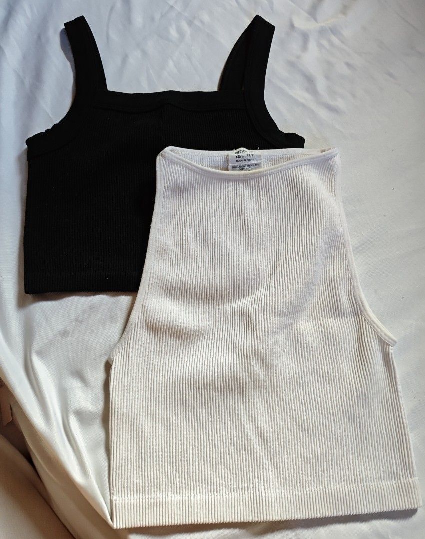 Cotton On Ribbed Tank Tops (Category: Sleeveless) located in Paranaque City. Submitted by anonymoosh (Listing ID 1462049494, Image 1). Description: Set of 2 ribbed tank tops: black (square neck, thick straps) and white (high neck, wide straps). Both cropped. Perfect wardrobe basics for layering or wearing solo. Take all for 500.