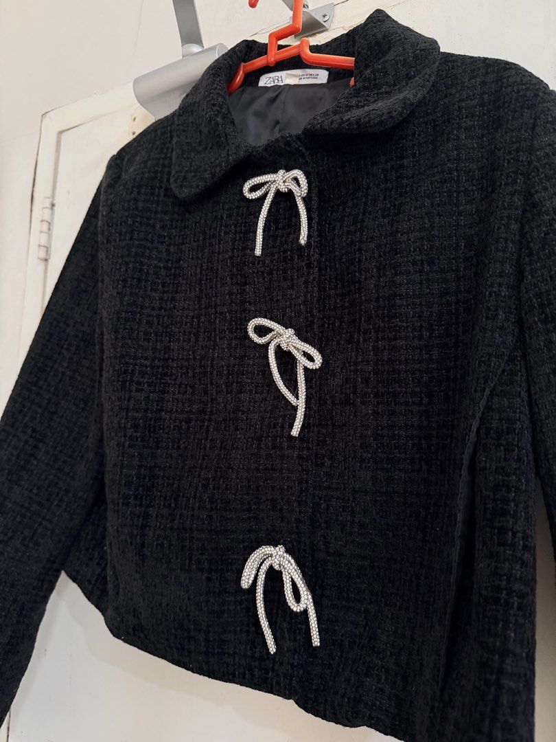 Cropped Tweed Jacket with Bow Details (Category: Coats, Jackets and Outerwear) located in Cebu City. Submitted by cutexoxoshop (Listing ID 1462188816, Image 2). Description: - cropped jacket - Dark grey tweed fabric - Three front bow details with rhinestones - Collar neckline - Long sleeves - Versatile for pairing with high-waisted bottoms - Adds a chic touch to any outfit.