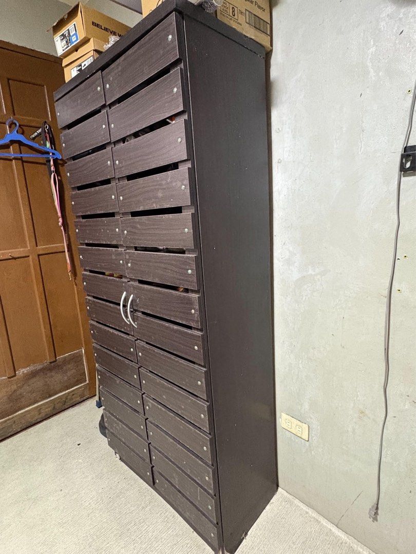 Dark Brown Shoes Cabinet with Spacious Storage (Category: Shelves, Cabinets & Racks) located in Quezon City. Submitted by zealfox-17 (Listing ID 1462072367, Image 2). Description: - Move out sale! - Dark brown shoe cabinet - Plenty of storage space - Sturdy and durable construction - Perfect for home organization - Dimensions: Approx. 65 inches (H) x 24 inches (W) - Price: Php 5,600 - Don't miss out on this great deal!.