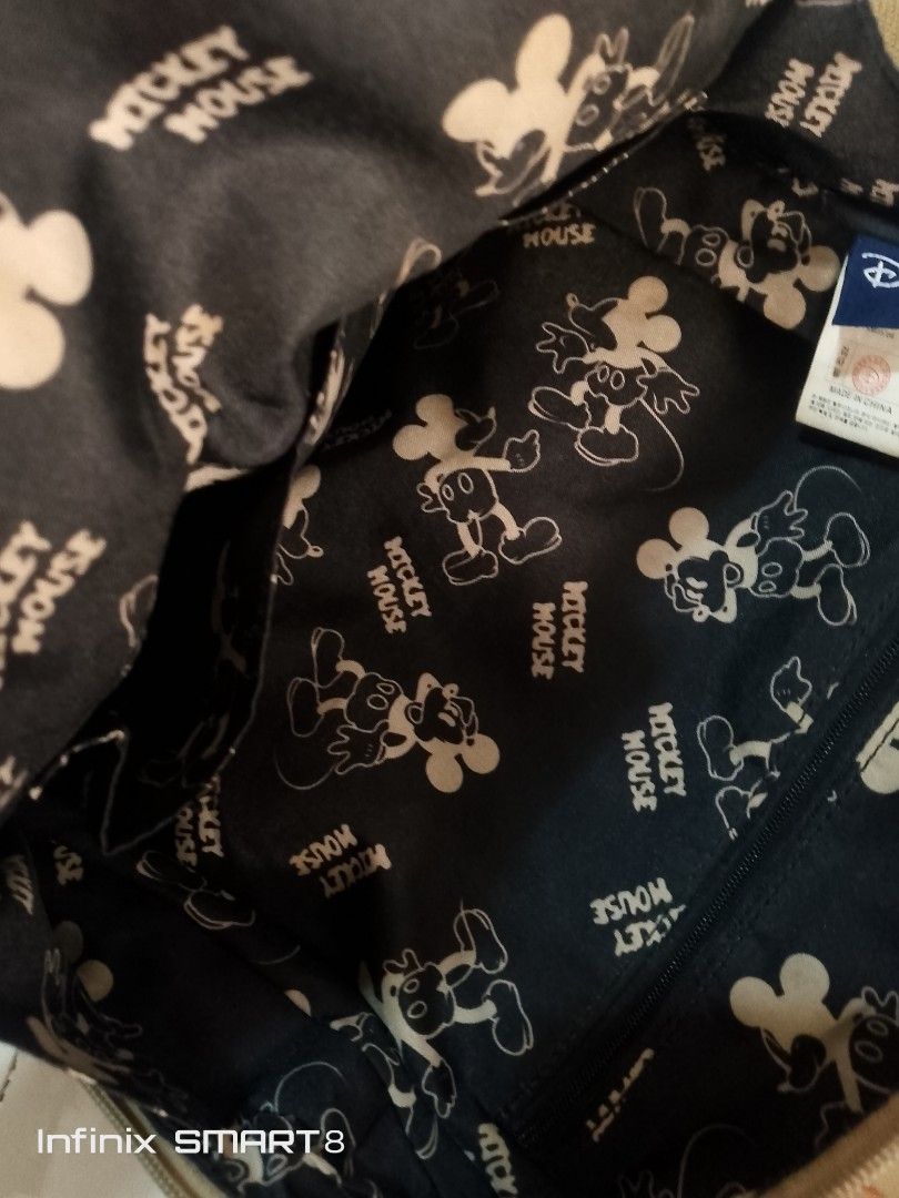 Disney Mickey Mouse Vintage Print Backpack (Category: Backpacks) located in Dasmarinas. Submitted by johnkho (Listing ID 1462129321, Image 3). Description: - Adorable Disney backpack featuring a vintage Mickey Mouse print all over. - Tan straps and handle for a classic look. - Interior lining also boasts a fun Mickey Mouse pattern. - Secure zip closure to keep your belongings safe. - Perfect for daily use, school, or a fun getaway..