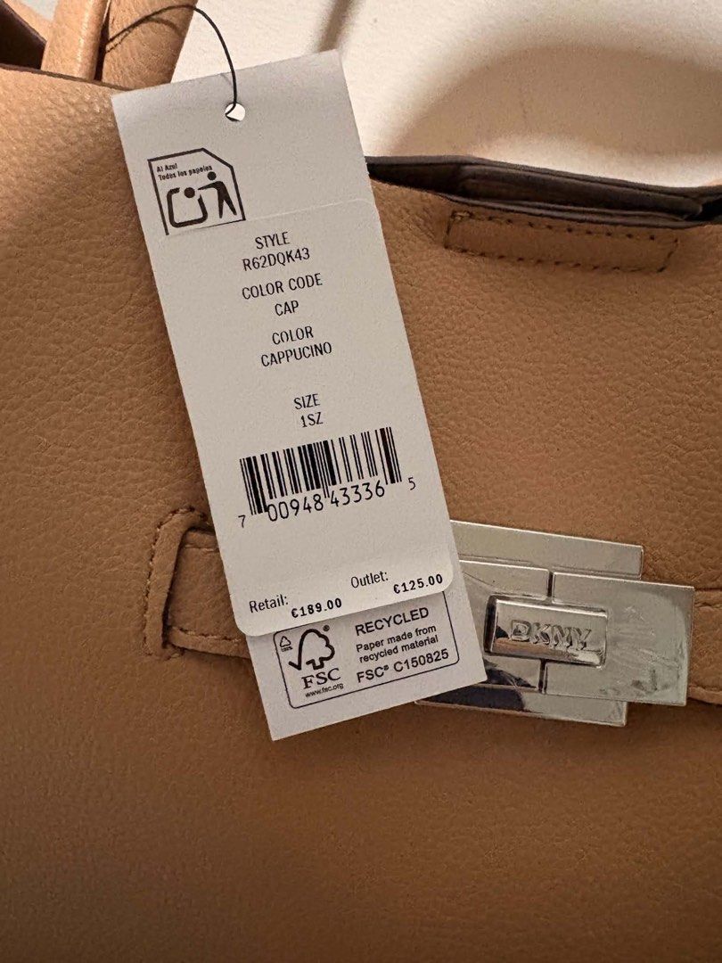 DKNY TOTE BAG (Category: Tote Bags) located in Quezon City. Submitted by pr0duct_paradize (Listing ID 1462083757, Image 3). Description: FOR SALE! BRAND NEW ORIGINAL PRICE 13k SELLING IT FOR 9k BINILI SA IRELAND CHECK THE PRICE AND TAG ON PHOTOS POSTED Original cappuccino-colored DKNY tote bag featuring a polished silver-tone buckle closure on the front. HELPING A FRIEND LOCATION: NOVALICHES QC PICK UP OR BOOK AN APP.