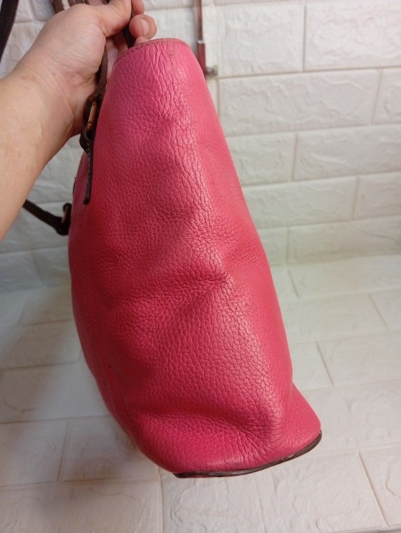 Dooney & Bourke Pink Leather Tote Bag (Category: Tote Bags) located in Las Pinas. Submitted by etoksi1234 (Listing ID 1462216231, Image 3). Description: Pre-loved Dooney & Bourke bright pink Pebble Grain Lexington tote featuring contrasting dark brown leather shoulder straps and a signature metal logo patch. Size: L-12" x H-10" x D-3.5".