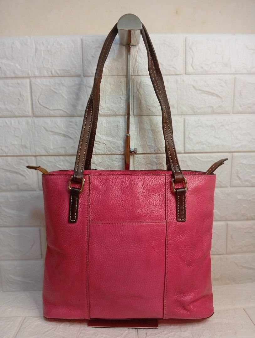 Dooney & Bourke Pink Leather Tote Bag (Category: Tote Bags) located in Las Pinas. Submitted by etoksi1234 (Listing ID 1462216231, Image 2). Description: Pre-loved Dooney & Bourke bright pink Pebble Grain Lexington tote featuring contrasting dark brown leather shoulder straps and a signature metal logo patch. Size: L-12" x H-10" x D-3.5".