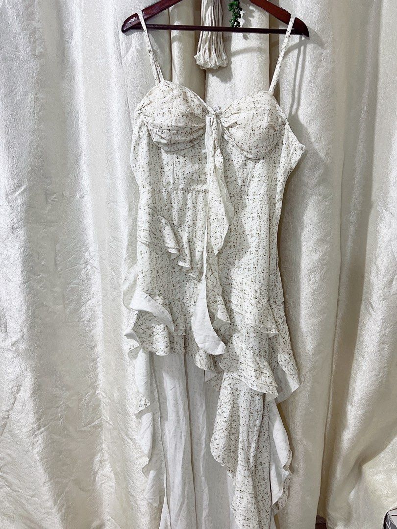 Dreamy whimsical Assymetrical dress (Category: Dresses) located in Cavite. Submitted by wishie_collects (Listing ID 1462236734, Image 3). Description: Brand New Size M Style & Design: It is a sweet, romantic, and whimsical mini-to-maxi high-low dress featuring a sweetheart neckline with a bustier-style bodice and a delicate front tie detail. Details: The dress is adorned with charming ruffled layers cascading down the front and features adjustabl