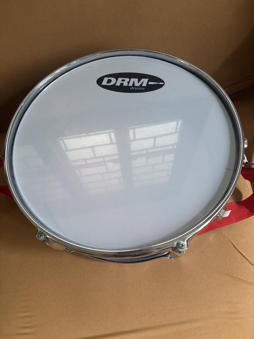 DRM Drums Blue Snare Drum with Strap (Category: Musical Instruments) located in Paranaque City. Submitted by goldboxph (Listing ID 1462067657, Image 2). Description: - Blue snare drum from DRM Drums - White drum head featuring the brand logo - Comes with a red strap - Ideal for both practice sessions and live performances - Ready for its next owner!.
