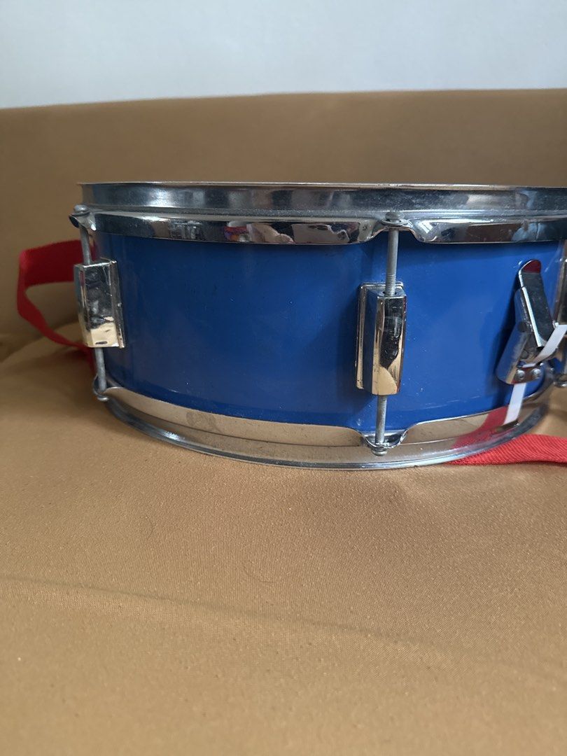 DRM Drums Blue Snare Drum with Strap (Category: Musical Instruments) located in Paranaque City. Submitted by goldboxph (Listing ID 1462067657, Image 3). Description: - Blue snare drum from DRM Drums - White drum head featuring the brand logo - Comes with a red strap - Ideal for both practice sessions and live performances - Ready for its next owner!.