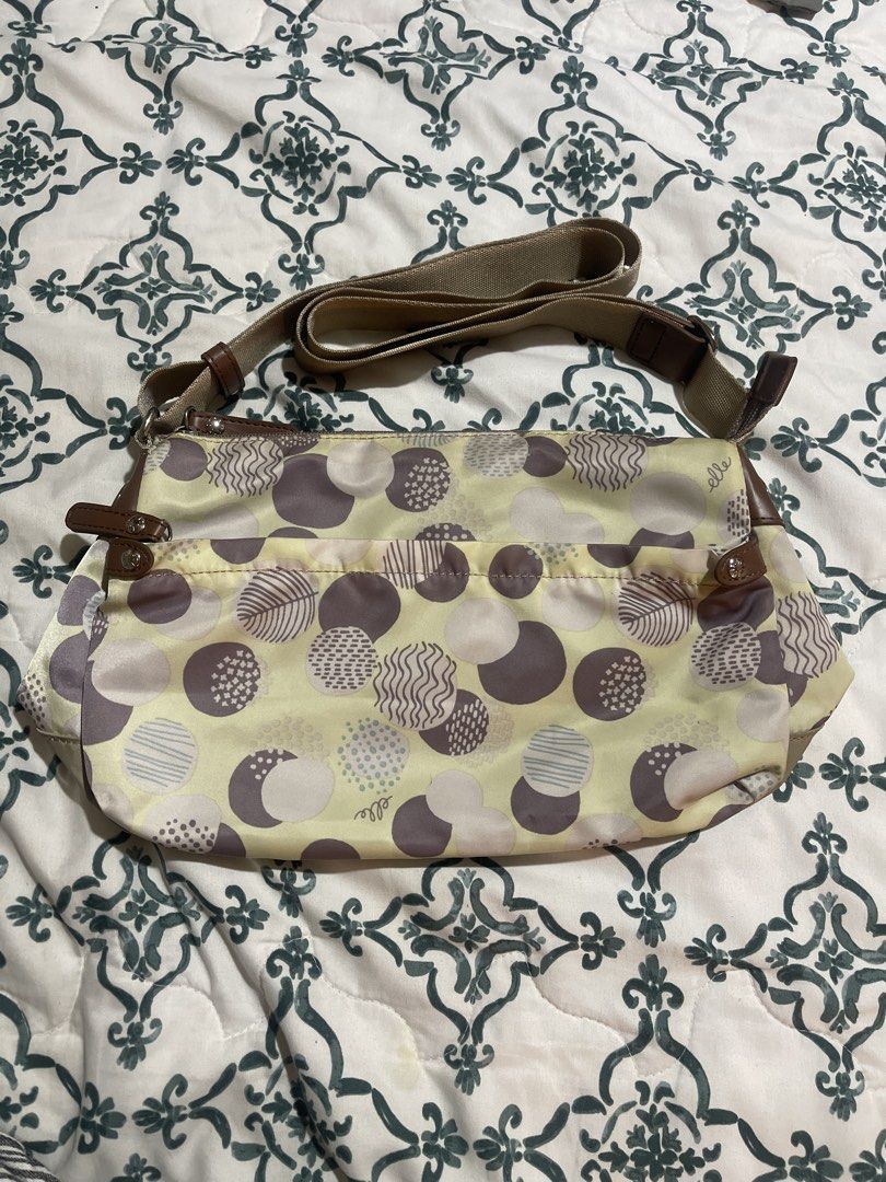ELLE Monogram Crossbody Bag (Category: Cross-body Bags) located in Quezon City. Submitted by donnabelle7572 (Listing ID 1462112238, Image 1). Description: - ELLE crossbody bag - Cute polka dot and leaf pattern - Light yellow with brown accents - Main zippered compartment - Exterior zippered pocket - Adjustable strap - Ideal for everyday use.