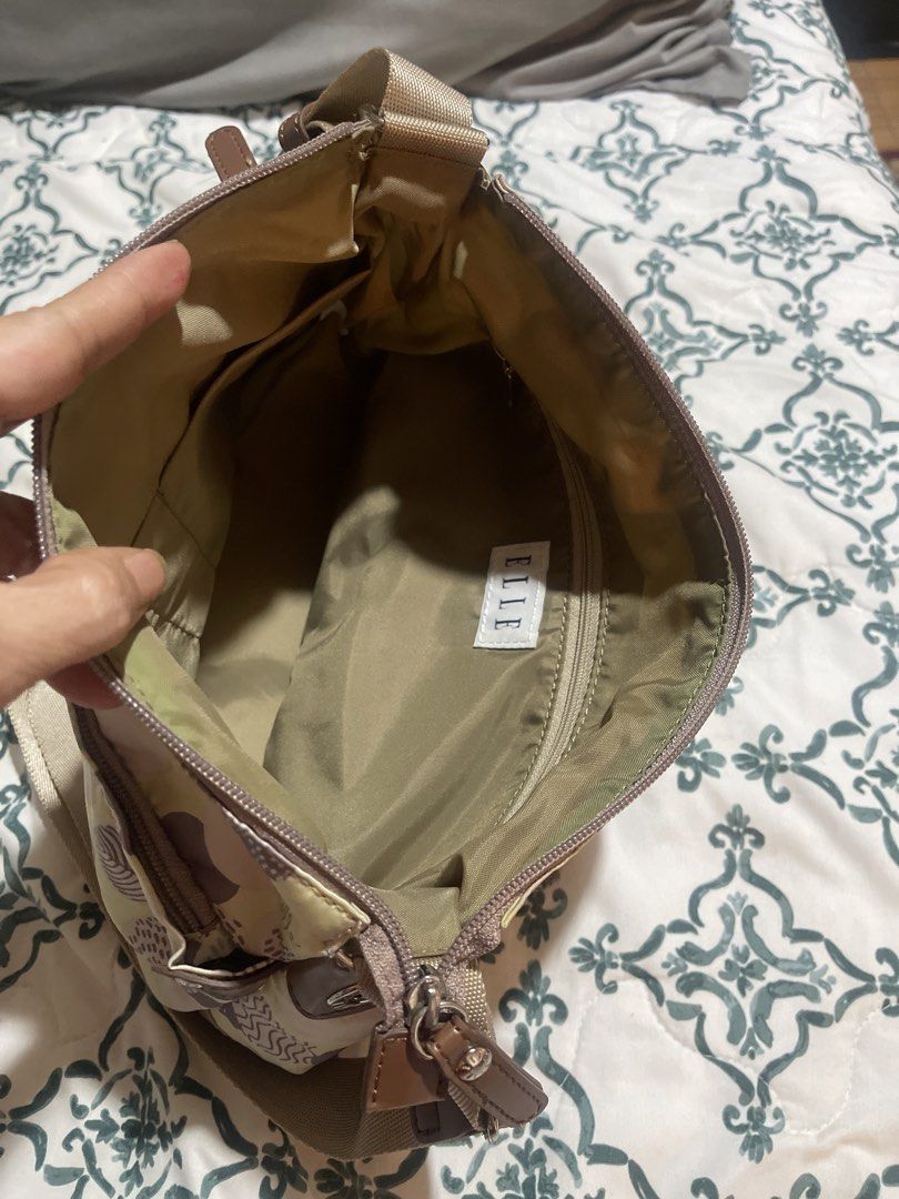 ELLE Monogram Crossbody Bag (Category: Cross-body Bags) located in Quezon City. Submitted by donnabelle7572 (Listing ID 1462112238, Image 3). Description: - ELLE crossbody bag - Cute polka dot and leaf pattern - Light yellow with brown accents - Main zippered compartment - Exterior zippered pocket - Adjustable strap - Ideal for everyday use.