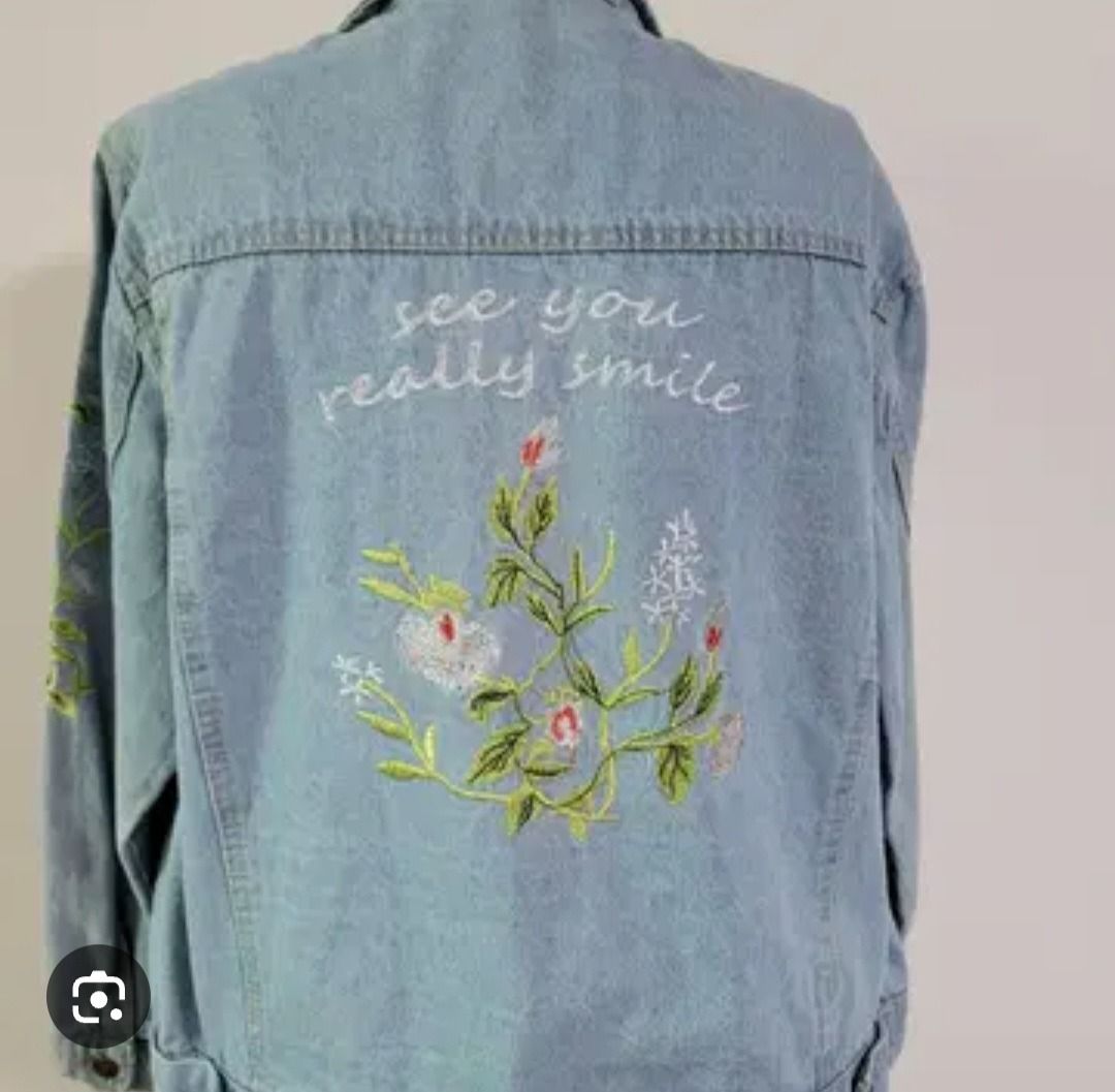 Embroidered Denim Jacket with "See You Really Smile" (Category: Coats, Jackets and Outerwear) located in Manila. Submitted by katkween23 (Listing ID 1462063627, Image 2). Description: - Light wash denim jacket - Beautiful floral embroidery on the back - Features text "see you really smile" - Classic button-up style - Two chest pockets - Ideal for layering - Unique and eye-catching piece.