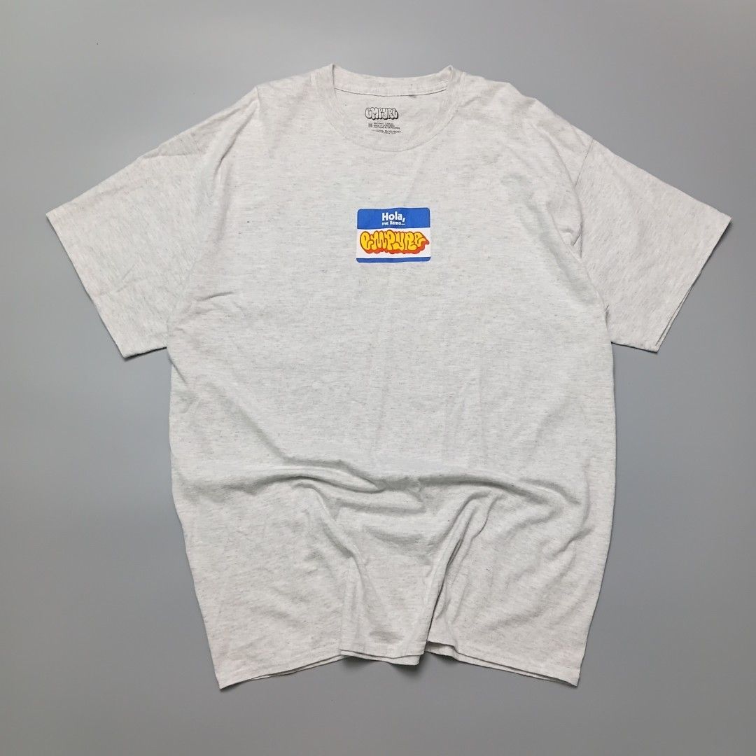 Empyre Hello Heather Grey T-Shirt, (Category: Tshirts & Polo Shirts ) located in Manila. Submitted by hustler_777 (Listing ID 1462180179, Image 1). Description: relaxed fit, a ribbed crew neck collar, and a tagless neckline. The graphic chest print displays a classic blue name tag sticker design reading "Hola, me llamo..." ("Hello, my name is...") with the Empyre streetwear brand name written inside in a bold graffiti bubble-letter script.