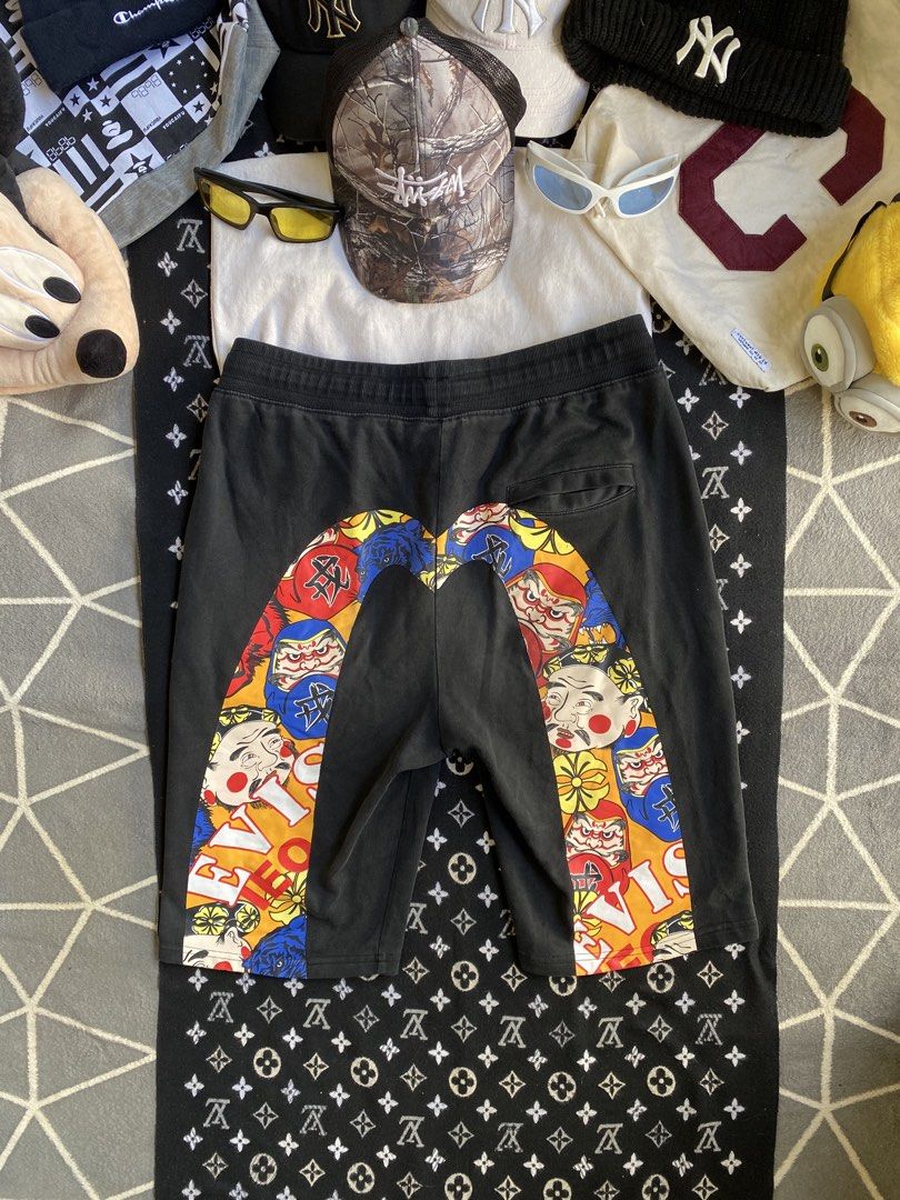 EVISU Daruma 1991 Graphic Shorts (Category: Shorts) located in Manila. Submitted by thriftfindnicarl (Listing ID 1462047792, Image 1). Description: - Black Evisu shorts - Iconic Daruma graphic on the back - Evisu 1991 logo on the front left leg - Comfortable drawstring waist - Ideal for streetwear enthusiasts - COLOR RATE 8/10.