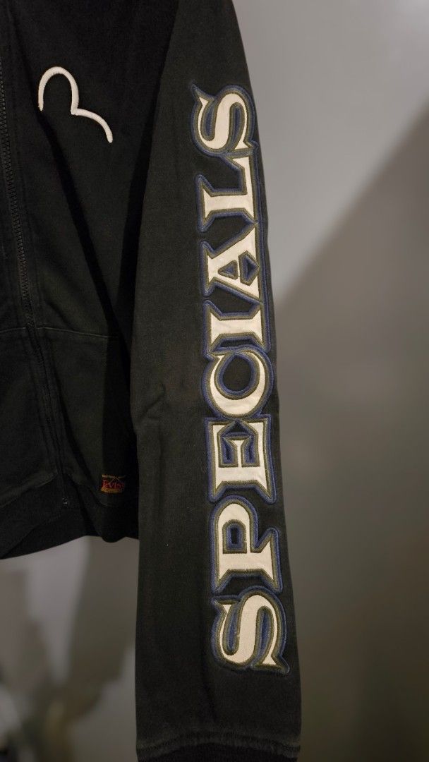 EVISU Zip-Up Hoodie (Category: Hoodies) located in Quezon City. Submitted by ShoesManila (Listing ID 1462208080, Image 2). Description: Width 19 Length 25 Arm length 24 - Black Evisu zip-up hoodie - Iconic Evisu logo on front - "Specials" text graphic on sleeve - Camouflage lining on the hood Ready to ship No COD Location: Diliman, QC .