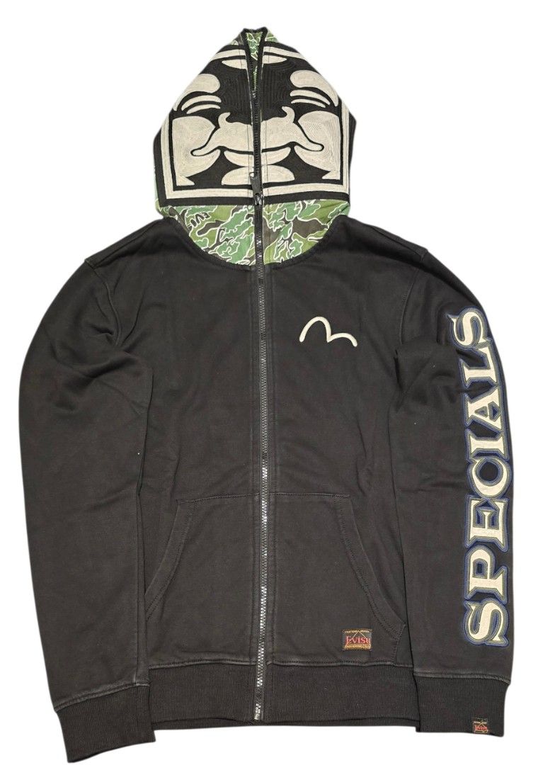EVISU Zip-Up Hoodie (Category: Hoodies) located in Quezon City. Submitted by ShoesManila (Listing ID 1462208080, Image 1). Description: Width 19 Length 25 Arm length 24 - Black Evisu zip-up hoodie - Iconic Evisu logo on front - "Specials" text graphic on sleeve - Camouflage lining on the hood Ready to ship No COD Location: Diliman, QC .
