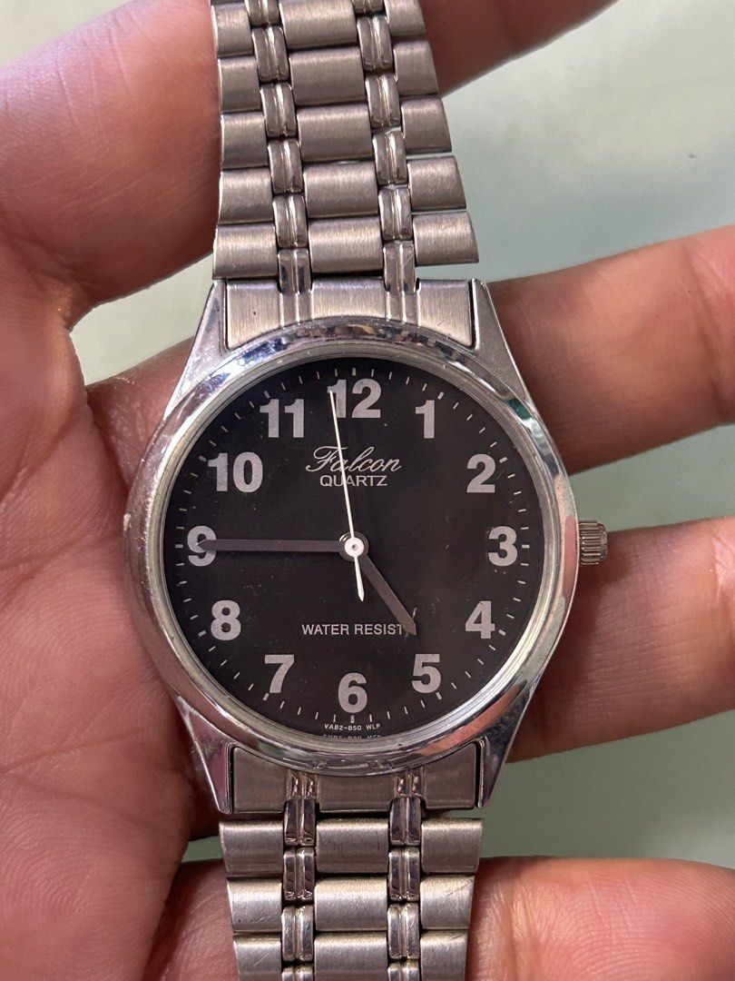 Falcon Quartz Water Resist Watch (Category: Men's Watches) located in Cavite. Submitted by mamamia73 (Listing ID 1462099997, Image 2). Description: Silver-tone Falcon watch. Black dial with clear Arabic numerals. Water resistant. Metal link strap with a fold-over clasp. Simple and classic design. Great for everyday wear. Works well..