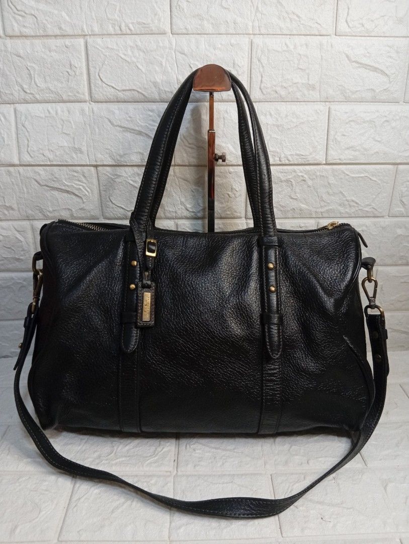FINO LEATHERWARE Black Leather Duffle Bag (Category: Shoulder Bags) located in Las Pinas. Submitted by etoksi1234 (Listing ID 1462181981, Image 1). Description: Pre-loved FINO LEATHERWARE black leather duffle bag. Top handles, detachable shoulder strap, gold hardware. Spacious interior, perfect for weekend trips. Size: L-14" x H-9" x D-6.6".