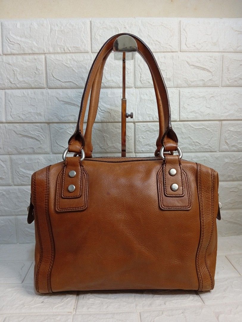 Fossil Marlow Brown Leather Satchel Shoulder Bag (Category: Shoulder Bags) located in Las Pinas. Submitted by etoksi1234 (Listing ID 1462142065, Image 2). Description: Pre-loved Fossil Marlow brown leather satchel bag featuring the brand's signature silver keyhole logo plate on the front. .