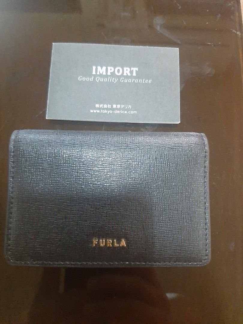 Furla Black Leather Card Holder (Category: Luxury Bags & Wallets) located in Bulacan. Submitted by edisoncert71953 (Listing ID 1462056567, Image 1). Description: - Authentic Furla card holder - Black textured leather - Secure snap button closure - Multiple interior card slots - Comes with 'Import Good Quality Guarantee' card - Ideal for keeping your essentials organized.