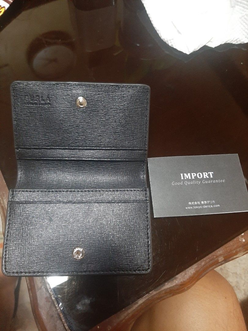 Furla Black Leather Card Holder (Category: Luxury Bags & Wallets) located in Bulacan. Submitted by edisoncert71953 (Listing ID 1462056567, Image 3). Description: - Authentic Furla card holder - Black textured leather - Secure snap button closure - Multiple interior card slots - Comes with 'Import Good Quality Guarantee' card - Ideal for keeping your essentials organized.