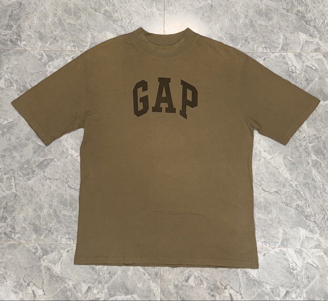 GAP T-shirt with Bird Graphic - Size S (Category: Shirts) located in Manila. Submitted by tanlaxfinds (Listing ID 1462047206, Image 1). Description: - Classic brown GAP t-shirt - Features a large white bird graphic on the back - Front displays the iconic GAP logo - Made in USA - 100% cotton for comfort - Tagged size S - Measurements: 22 inches (width) x 28 inches (length).