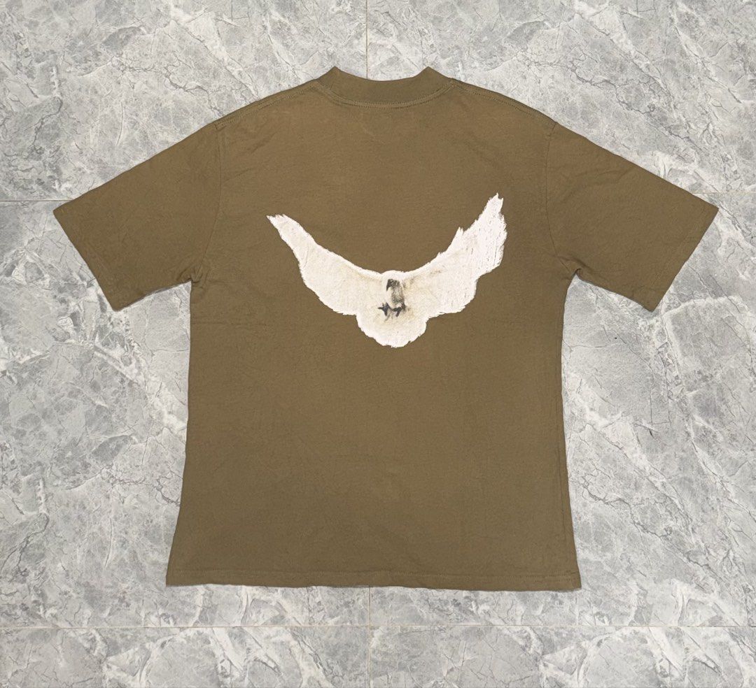 GAP T-shirt with Bird Graphic - Size S (Category: Shirts) located in Manila. Submitted by tanlaxfinds (Listing ID 1462047206, Image 2). Description: - Classic brown GAP t-shirt - Features a large white bird graphic on the back - Front displays the iconic GAP logo - Made in USA - 100% cotton for comfort - Tagged size S - Measurements: 22 inches (width) x 28 inches (length).