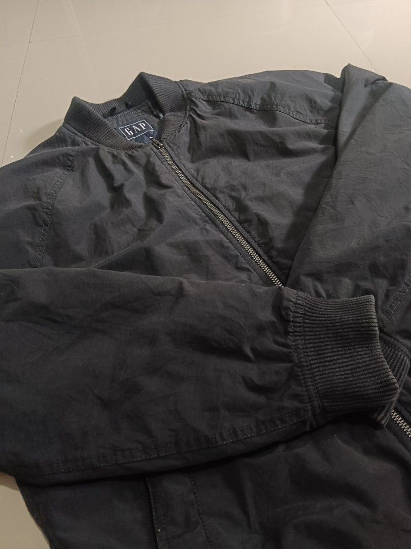GAP Water Resistant Windproof Bomber Jacket (Category: Coats, Jackets and Outerwear) located in Manila. Submitted by xelll7 (Listing ID 1462079063, Image 2). Description: - GAP Bomber Jacket - Color: Dark Grey - Size: L - Material: Water resistant and windproof - Features: Quilted lining, ribbed collar/cuffs/hem, two zip front pockets - Ideal for: Everyday wear, light outdoor activities.