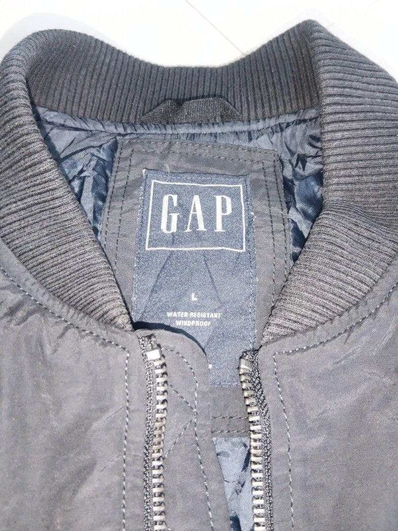 GAP Water Resistant Windproof Bomber Jacket (Category: Coats, Jackets and Outerwear) located in Manila. Submitted by xelll7 (Listing ID 1462079063, Image 3). Description: - GAP Bomber Jacket - Color: Dark Grey - Size: L - Material: Water resistant and windproof - Features: Quilted lining, ribbed collar/cuffs/hem, two zip front pockets - Ideal for: Everyday wear, light outdoor activities.
