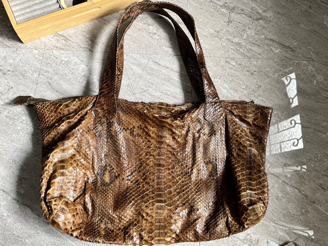 Genuine Python Snakeskin Tote Bag (Category: Tote Bags) located in Makati City. Submitted by Ina_Ndang (Listing ID 1462164701, Image 3). Description: - Genuine python snakeskin tote bag - Rich brown and tan scale pattern - Spacious interior, perfect for everyday use - Comfortable shoulder straps - Unique statement piece ~~~~~~~~~ Approximate dimension: 17.5 inches width, 13 inches height, 19 inches bag handles/drop - No flaws, preloved - Payment 