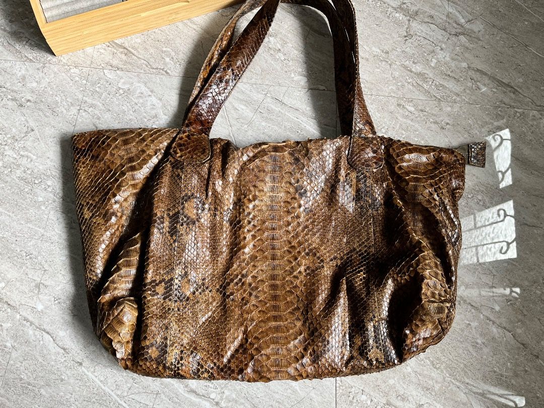 Genuine Python Snakeskin Tote Bag (Category: Tote Bags) located in Makati City. Submitted by Ina_Ndang (Listing ID 1462164701, Image 2). Description: - Genuine python snakeskin tote bag - Rich brown and tan scale pattern - Spacious interior, perfect for everyday use - Comfortable shoulder straps - Unique statement piece ~~~~~~~~~ Approximate dimension: 17.5 inches width, 13 inches height, 19 inches bag handles/drop - No flaws, preloved - Payment 