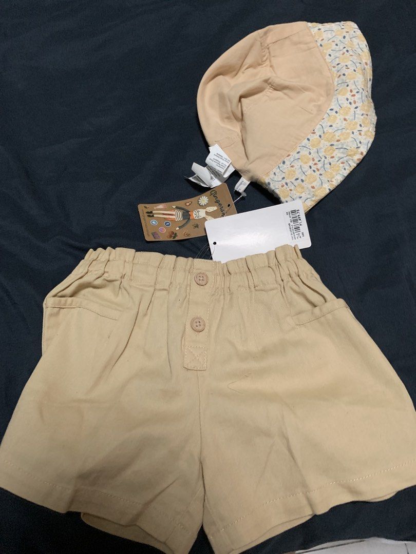 Gingersnaps Tiny Baby Hat and Shorts Set (Category: Babies & Kids Fashion) located in Malabon City. Submitted by vewonica (Listing ID 1462138285, Image 1). Description: - Cute Gingersnaps Tiny set - Includes bucket hat with floral print lining - Matching beige shorts with elastic waistband and button details - Ideal for summer adventures - Both pieces have tags attached.