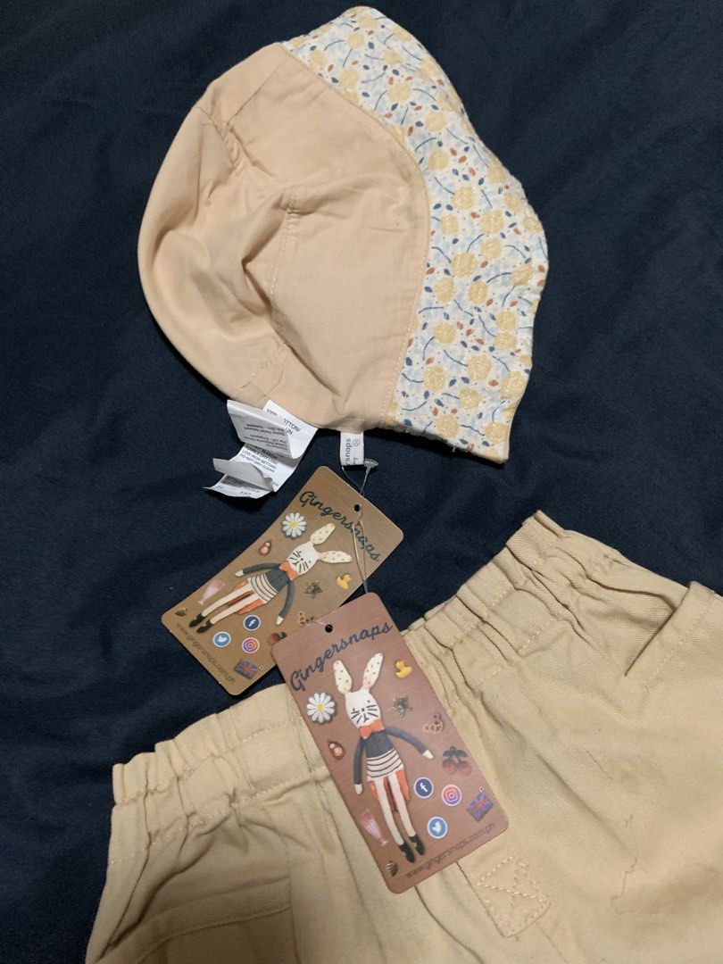 Gingersnaps Tiny Baby Hat and Shorts Set (Category: Babies & Kids Fashion) located in Malabon City. Submitted by vewonica (Listing ID 1462138285, Image 2). Description: - Cute Gingersnaps Tiny set - Includes bucket hat with floral print lining - Matching beige shorts with elastic waistband and button details - Ideal for summer adventures - Both pieces have tags attached.