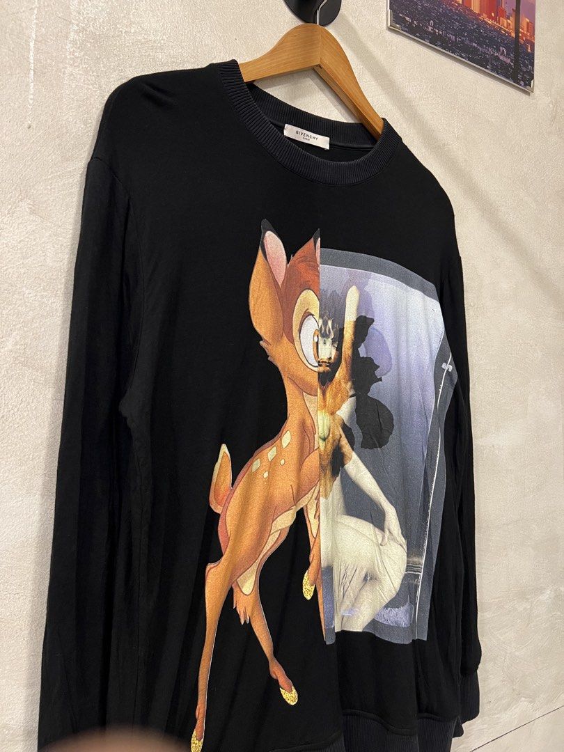 Givenchy Bambi Graphic Print Crewneck (Category: Others Tops) located in Quezon City. Submitted by shanks. (Listing ID 1462098708, Image 3). Description: This is a black Givenchy crewneck sweatshirt featuring an iconic split graphic of Bambi alongside a vintage portrait collage. Size : Large Dimensions : Length: 29 inches Width: 21 inches Shoulder : 19 inches Sleeve :23 inches Sign of wear in good condition .