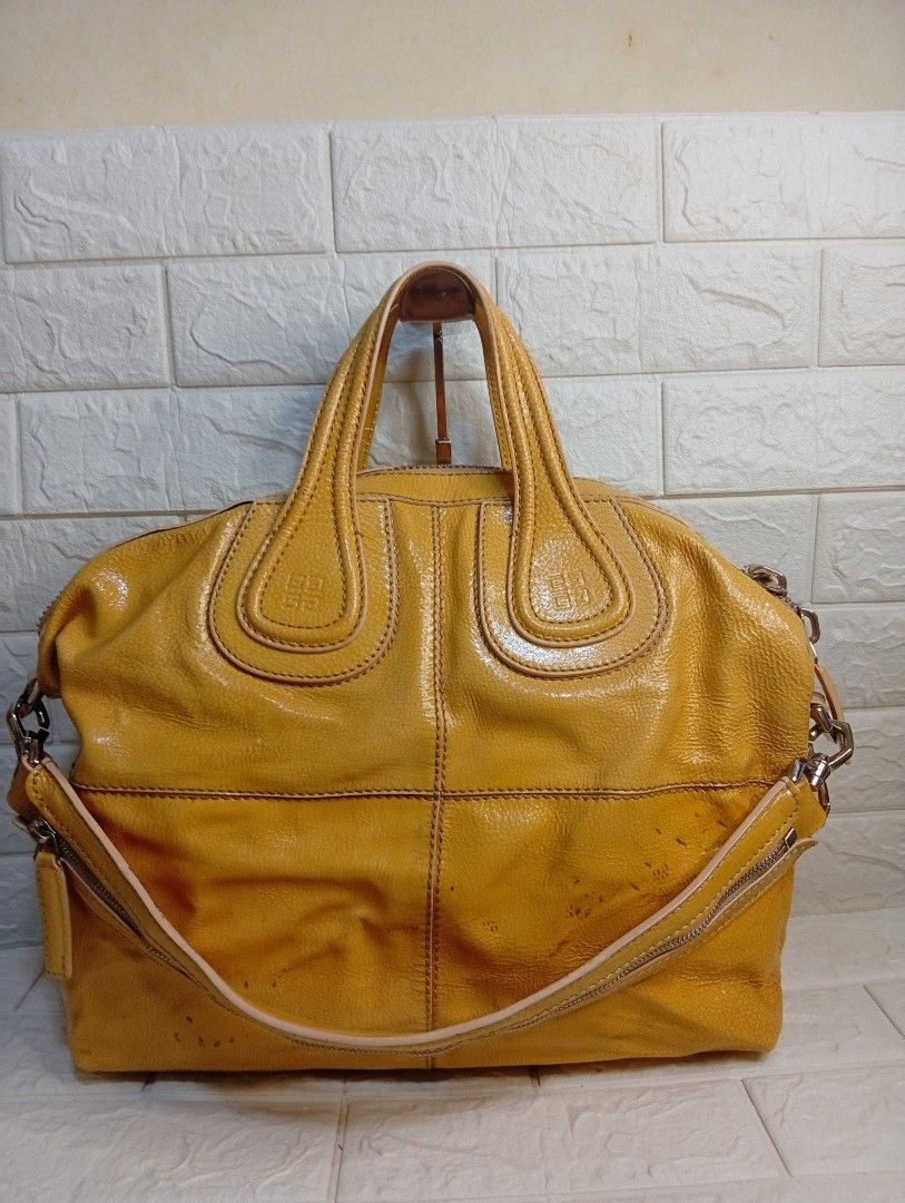 Givenchy Yellow Leather Nightingale Bag (Category: Shoulder Bags) located in Las Pinas. Submitted by etoksi1234 (Listing ID 1462213285, Image 1). Description: Pre-loved Givenchy Yellow Patent Leather Nightingale bag. Includes detachable strap and spacious interior. Givenchy underzip, coded. Silver tone hardware. (ISSUE-color transfer). .