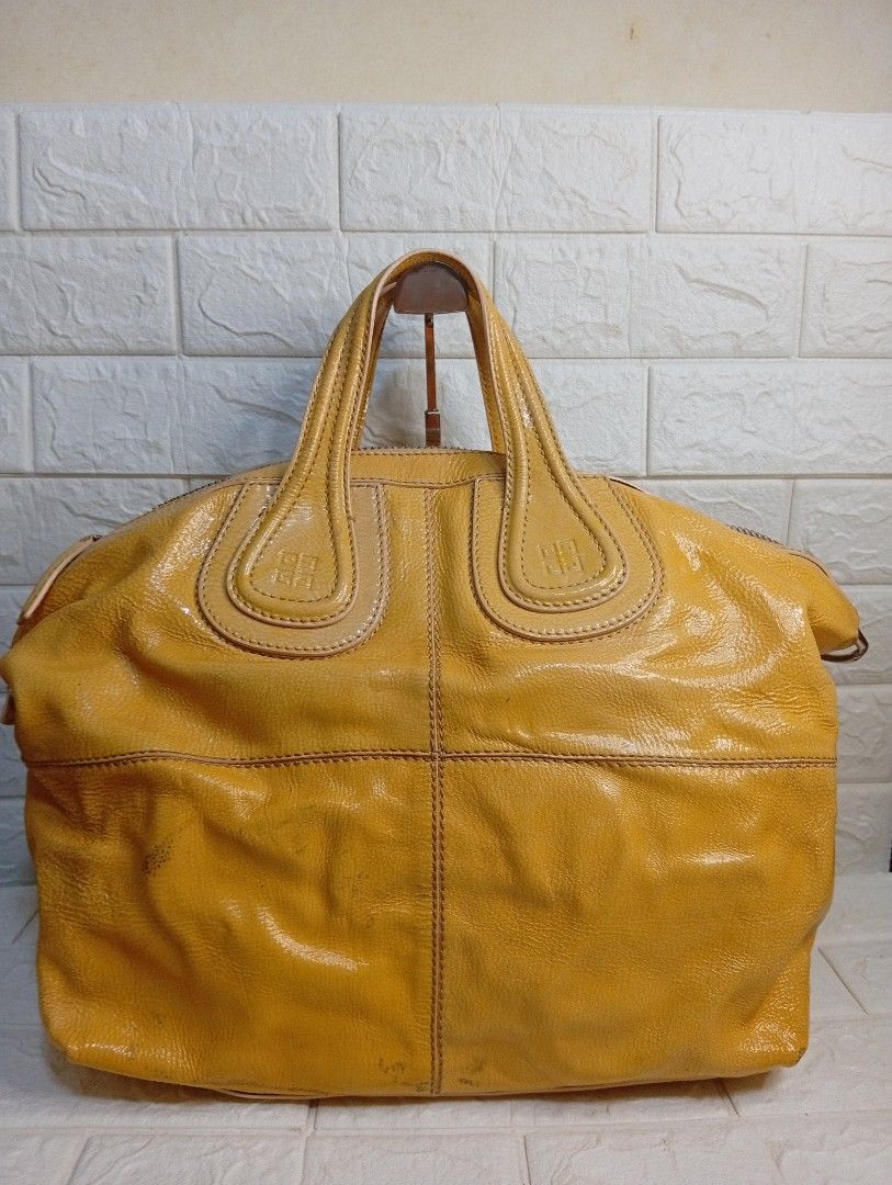 Givenchy Yellow Leather Nightingale Bag (Category: Shoulder Bags) located in Las Pinas. Submitted by etoksi1234 (Listing ID 1462213285, Image 2). Description: Pre-loved Givenchy Yellow Patent Leather Nightingale bag. Includes detachable strap and spacious interior. Givenchy underzip, coded. Silver tone hardware. (ISSUE-color transfer). .