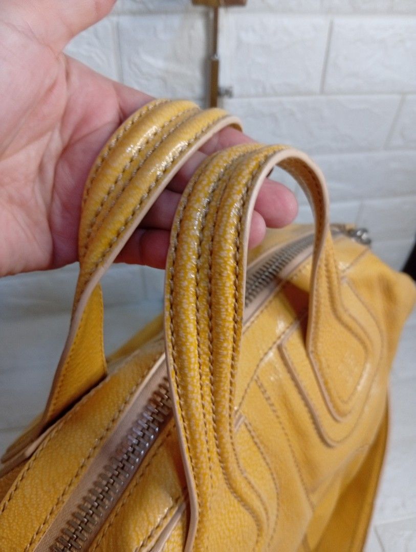 Givenchy Yellow Leather Nightingale Bag (Category: Shoulder Bags) located in Las Pinas. Submitted by etoksi1234 (Listing ID 1462213285, Image 3). Description: Pre-loved Givenchy Yellow Patent Leather Nightingale bag. Includes detachable strap and spacious interior. Givenchy underzip, coded. Silver tone hardware. (ISSUE-color transfer). .