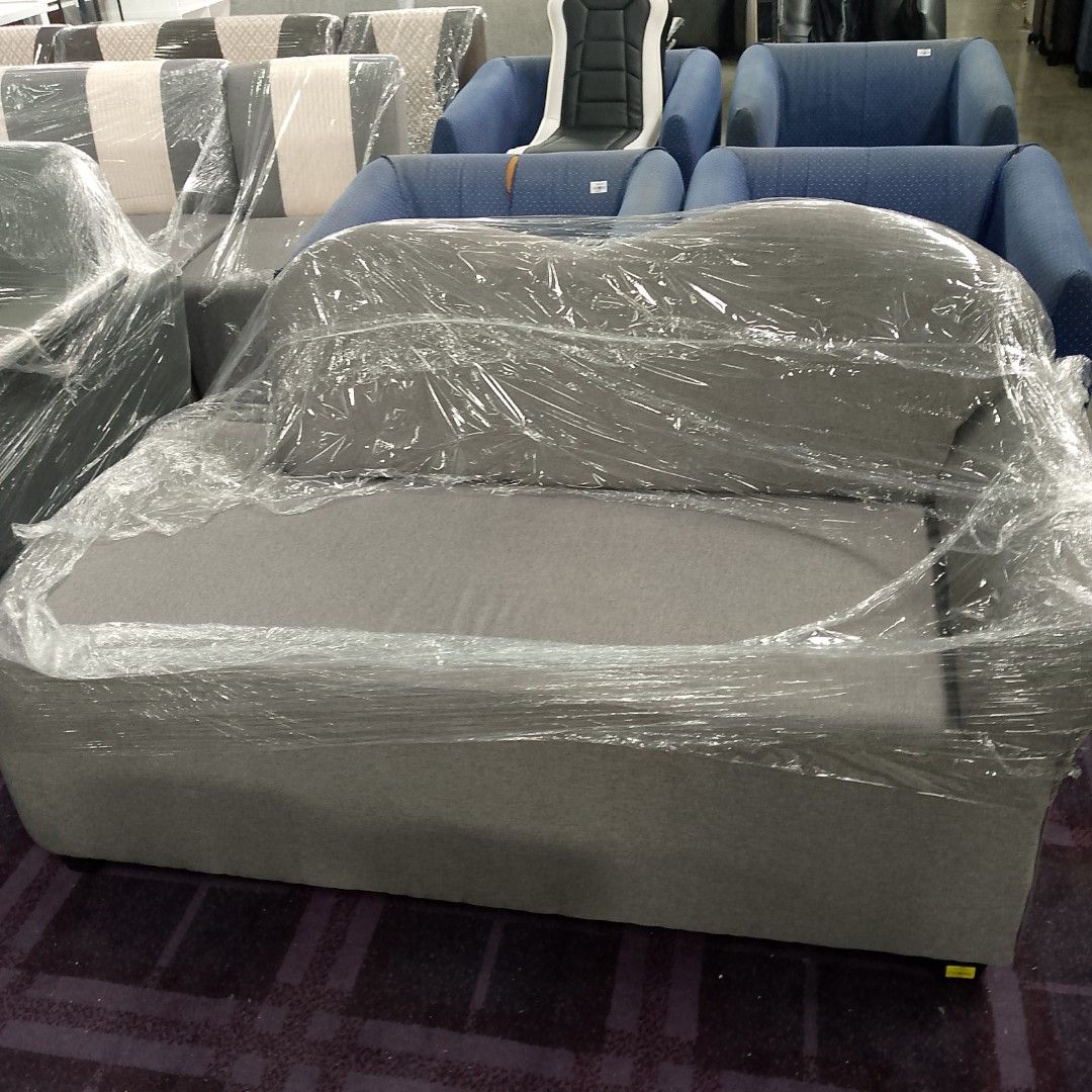 Grey 2-seater sofa, wrapped in plastic (Category: Sofas) located in Manila. Submitted by cleverwolf.07545a (Listing ID 1462047889, Image 1). Description: - Brand new grey 2-seater sofa - Still wrapped in protective plastic - Modern design - Ideal for living rooms or apartments - Ready for its new home.