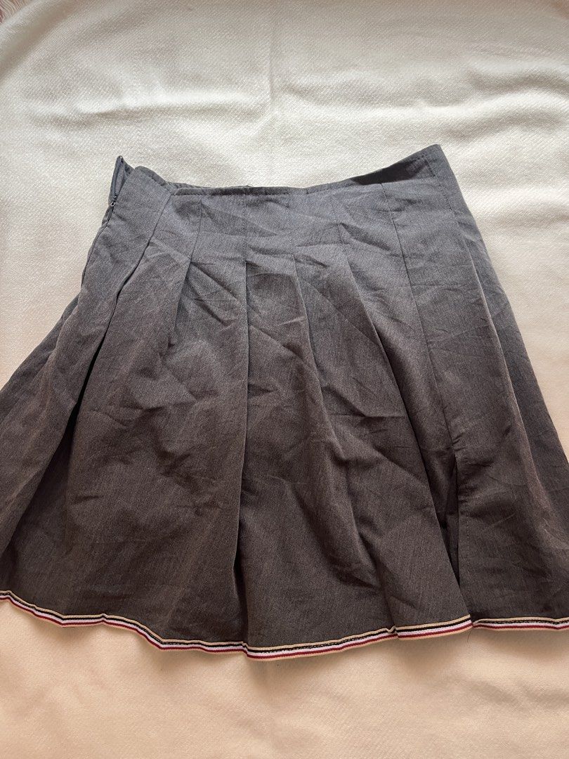 Grey Pleated Skirt with Striped Hem (Category: Skirts) located in Manila. Submitted by chimcheese (Listing ID 1462134214, Image 1). Description: - Grey pleated skirt - Features a cute striped trim along the hem (red, white, black) - Side zipper closure - Ideal for school uniform style or cosplay outfits.