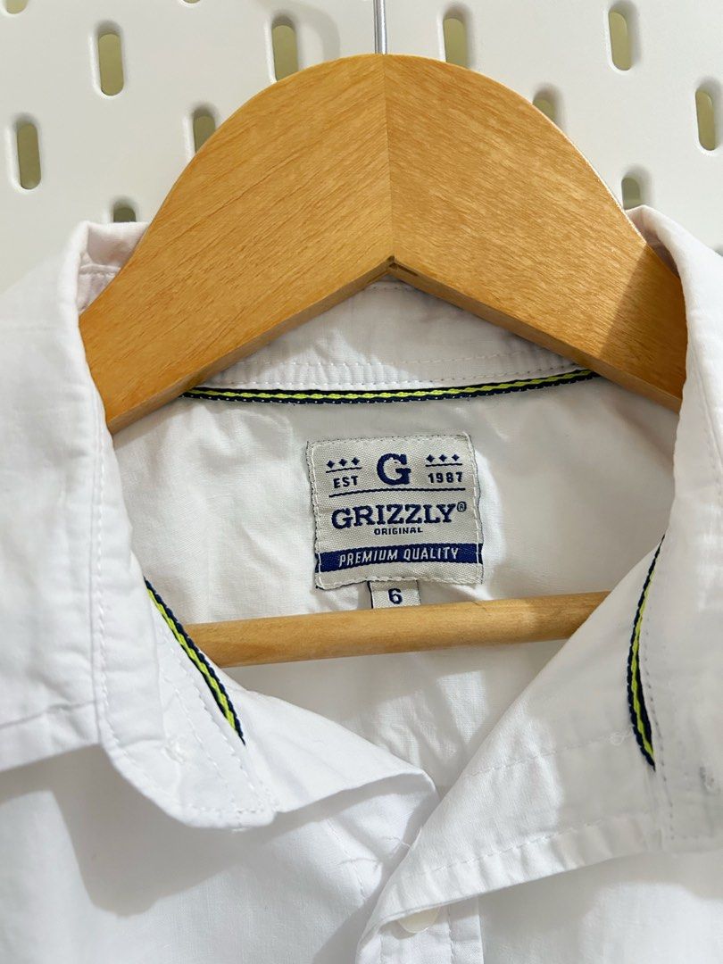 Grizzly White Long- Sleeve Button-Down (Category: Babies & Kids Fashion) located in Manila. Submitted by maison_marie (Listing ID 1462190324, Image 2). Description: Brand: Grizzly Original Unisex Size: 6 on tag Purchased from SM Department Store in February 2025 and used only once for a rondalla concert.My daughter was already 10 years old when she wore it. She is petite, so it fit her well. Location: Malate, Manila Available for pick-up or same-