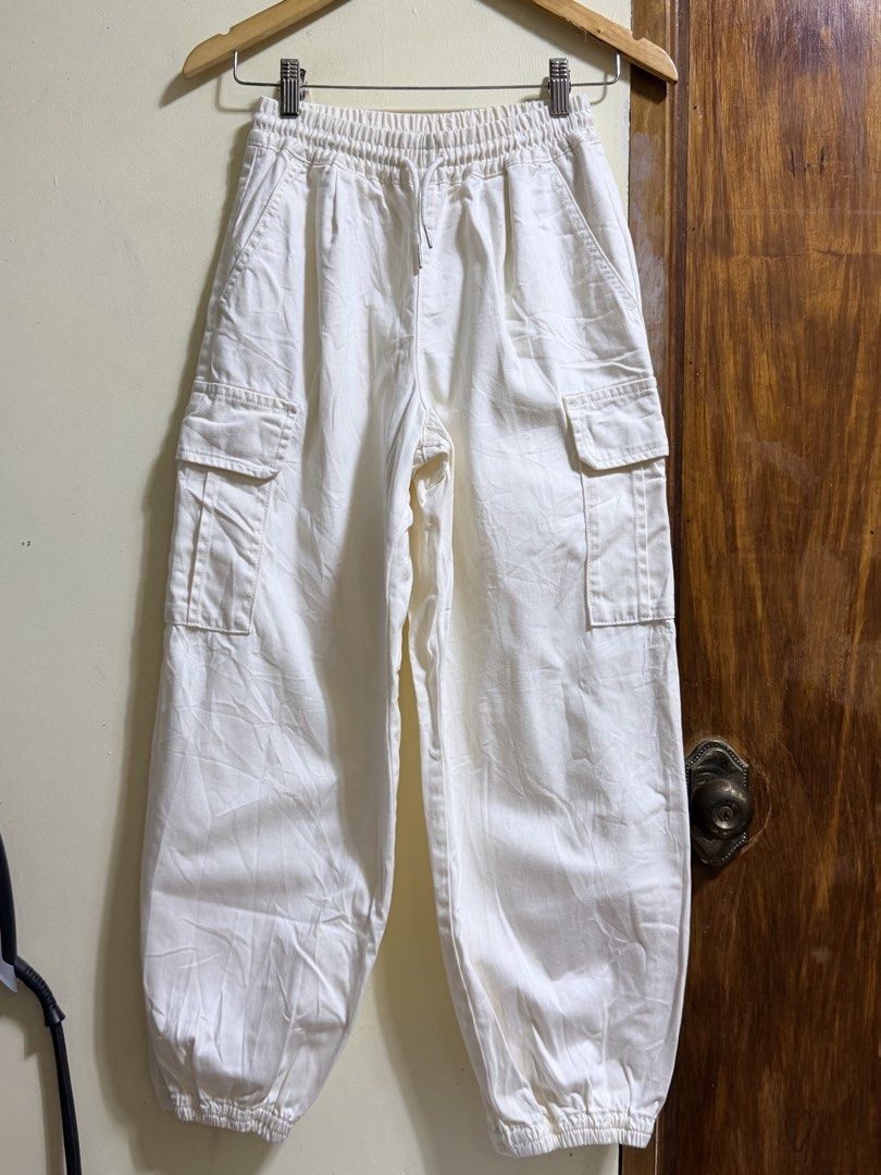 GU White Cargo Pants (Category: Other Bottoms) located in Paete. Submitted by skydruemadison (Listing ID 1462166656, Image 1). Description: - Brand: GU - Color: White - Style: Cargo Pants - Waistband: Elastic with drawstring - Pockets: 2 side pockets, 2 cargo pockets - Cuffs: Elastic at the bottom - Features: Comfortable, casual, great for everyday wear.
