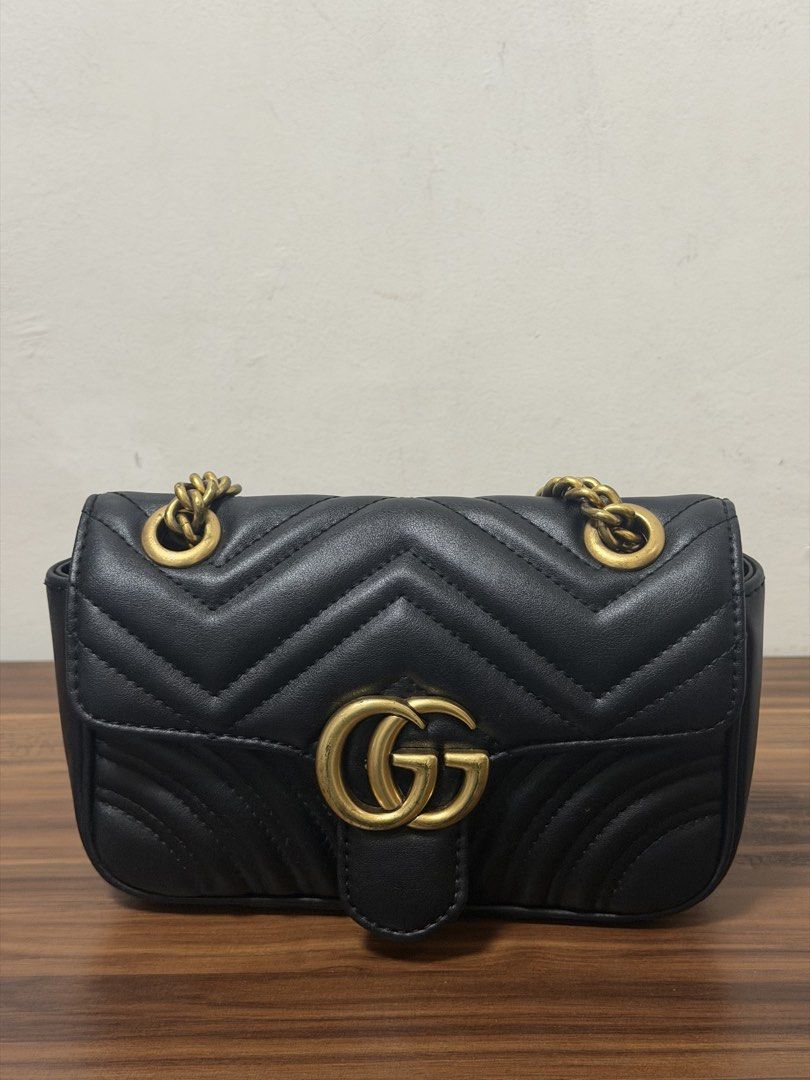 Gucci Marmont Small Shoulder Bag Black Leather (Category: Luxury Bags & Wallets) located in Quezon City. Submitted by shop_mnl (Listing ID 1462052149, Image 2). Description: - Black quilted leather - Iconic GG logo hardware - Unique heart detail on the back - Gold chain strap - Ideal for nights out or everyday use - Fits all your essentials.