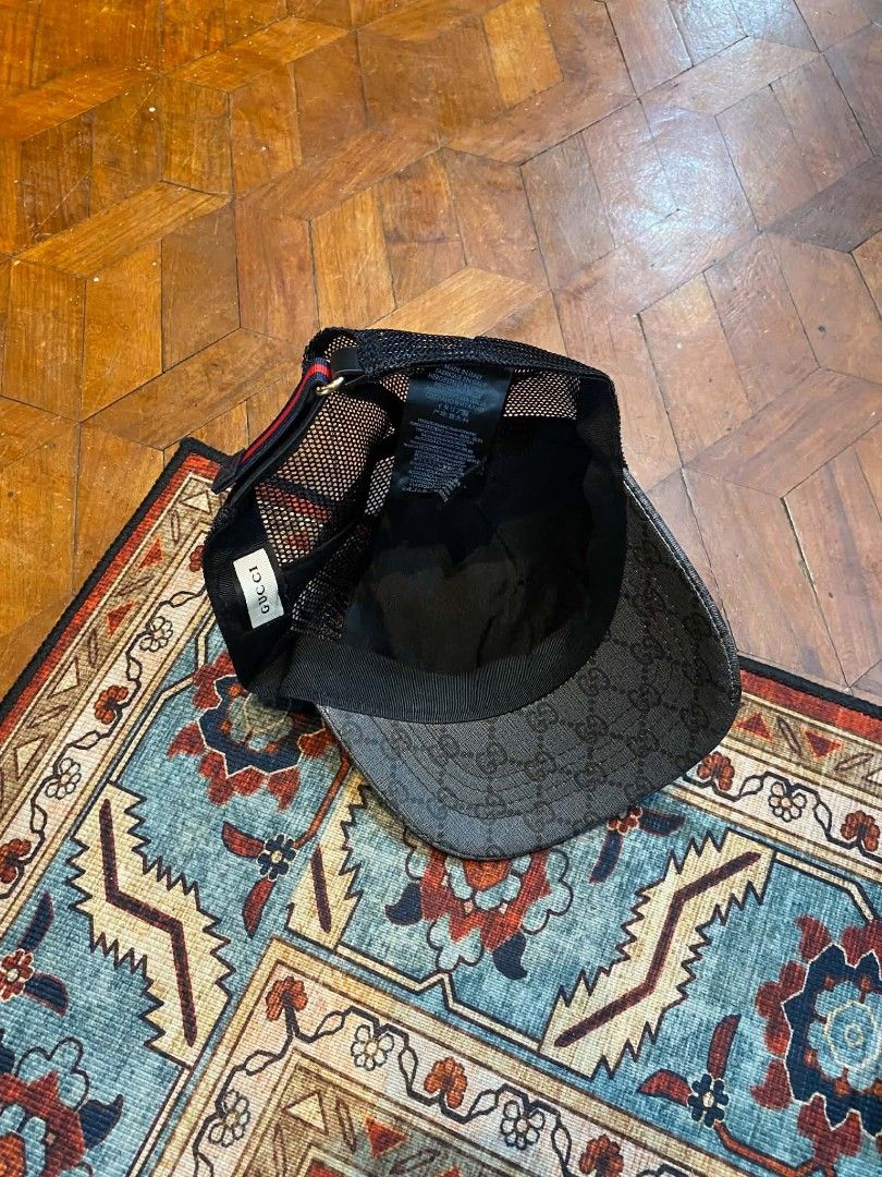Gucci Monogrammed Trucker Cap with Wolf Design (Category: Caps & Hats) located in Pasig City. Submitted by paulclzdo (Listing ID 1462132925, Image 2). Description: - Authentic Grey Gucci Trucker Cap - All-over GG Monogram Pattern - Front panel with unique wolf graphic and Gucci logo - Breathable black mesh back - Adjustable strap for customized fit - Perfect for casual and stylish everyday wear.