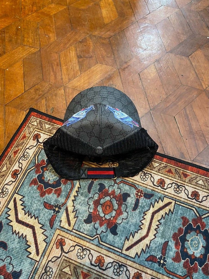 Gucci Monogrammed Trucker Cap with Wolf Design (Category: Caps & Hats) located in Pasig City. Submitted by paulclzdo (Listing ID 1462132925, Image 3). Description: - Authentic Grey Gucci Trucker Cap - All-over GG Monogram Pattern - Front panel with unique wolf graphic and Gucci logo - Breathable black mesh back - Adjustable strap for customized fit - Perfect for casual and stylish everyday wear.