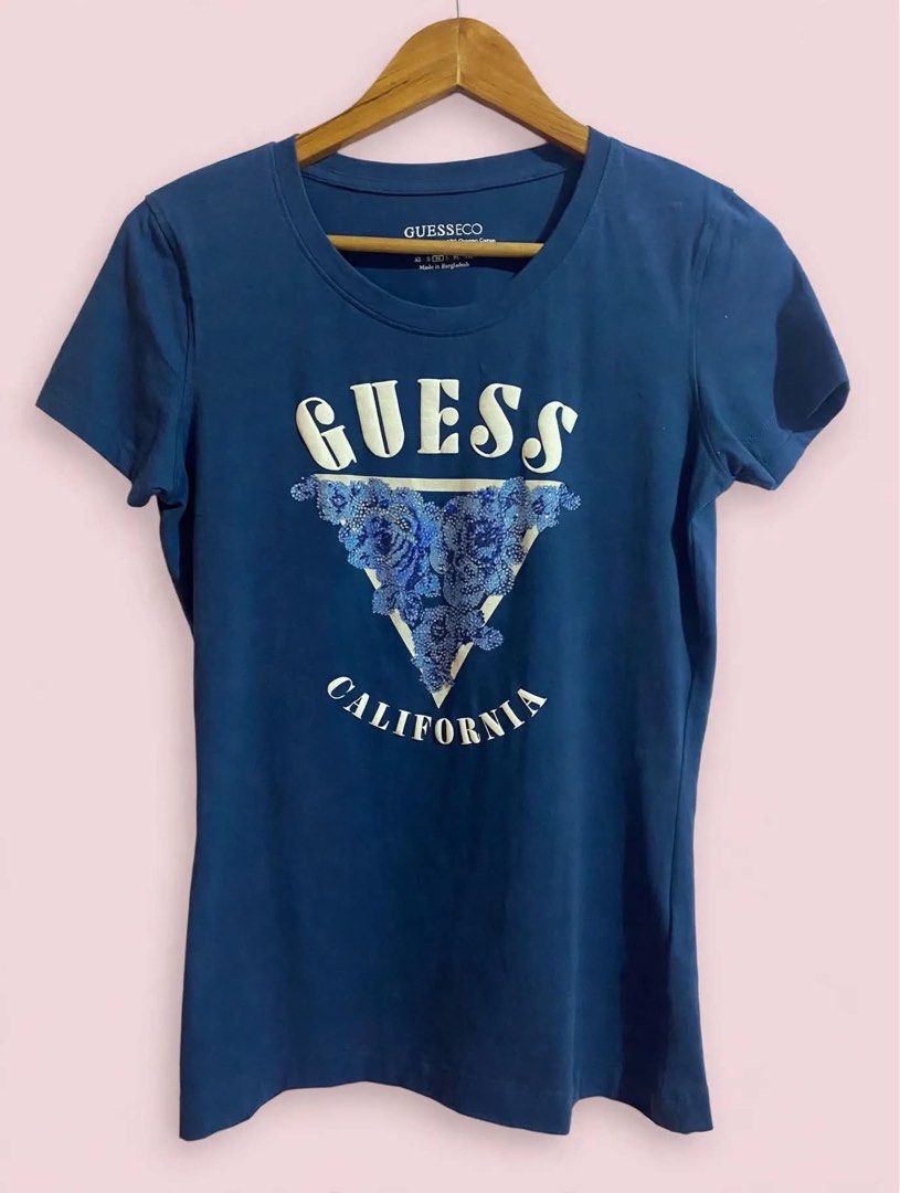 Guess California Blue T-shirt (Category: Shirts) located in Cavite. Submitted by luxxe.muse (Listing ID 1462092016, Image 1). Description: - Classic blue Guess t-shirt - Features iconic California triangle logo - Unique floral detail within the logo - Comfortable 100% cotton material - Perfect for casual outfits, pairs well with jeans - Bust 36.