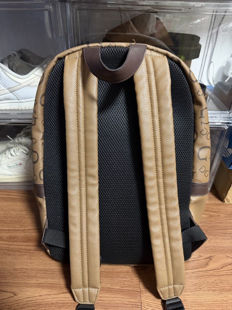 Guess Insignia Monogram Backpack Brown (Category: Backpacks) located in Cainta. Submitted by tinpalma (Listing ID 1462090631, Image 3). Description: - Stylish brown Guess backpack with all-over monogram print. - Features a convenient front zip pocket. - Main compartment includes internal pockets for organization. - Padded back and adjustable straps ensure maximum comfort. - Ideal for everyday use, school, or travel adventures..