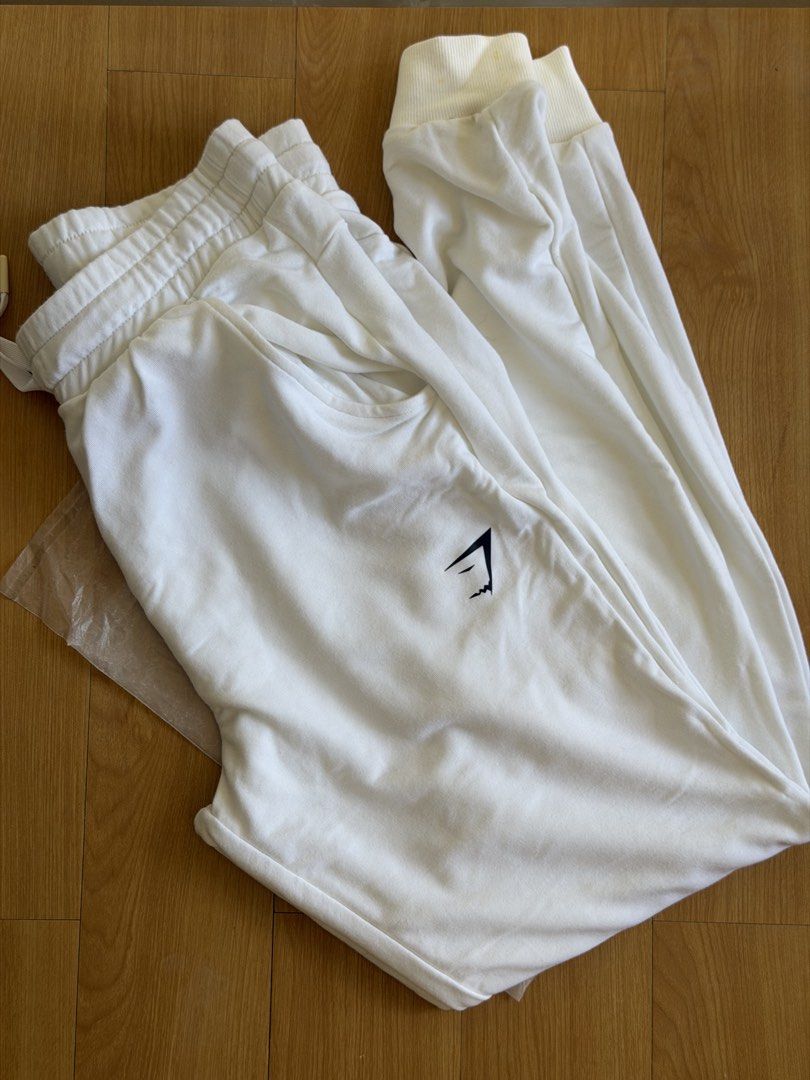 Gymshark Joggers White (Category: Joggers) located in Bacolor. Submitted by ieshaaa.1 (Listing ID 1462057821, Image 1). Description: - White joggers with iconic Gymshark logo - Comfortable elastic waistband with adjustable drawstring - Cuffed ankles for a snug fit - Ideal for both workouts and casual lounging - Pre-loved and ready for its next adventure!.