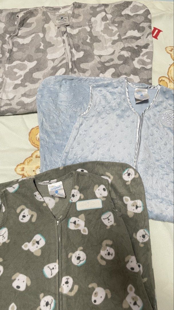 HALO SleepSack Wearable Blanket Bundle - Various Prints (Category: Babies & Kids Fashion) located in San Jose del Monte. Submitted by momma_buys (Listing ID 1462114001, Image 1). Description: - Bundle of three HALO SleepSack wearable blankets - Includes: grey camouflage, light blue textured, and grey with white dog faces prints - Sleeveless design for safe sleep - Convenient top-to-bottom zipper - Keeps your little one warm and cozy.