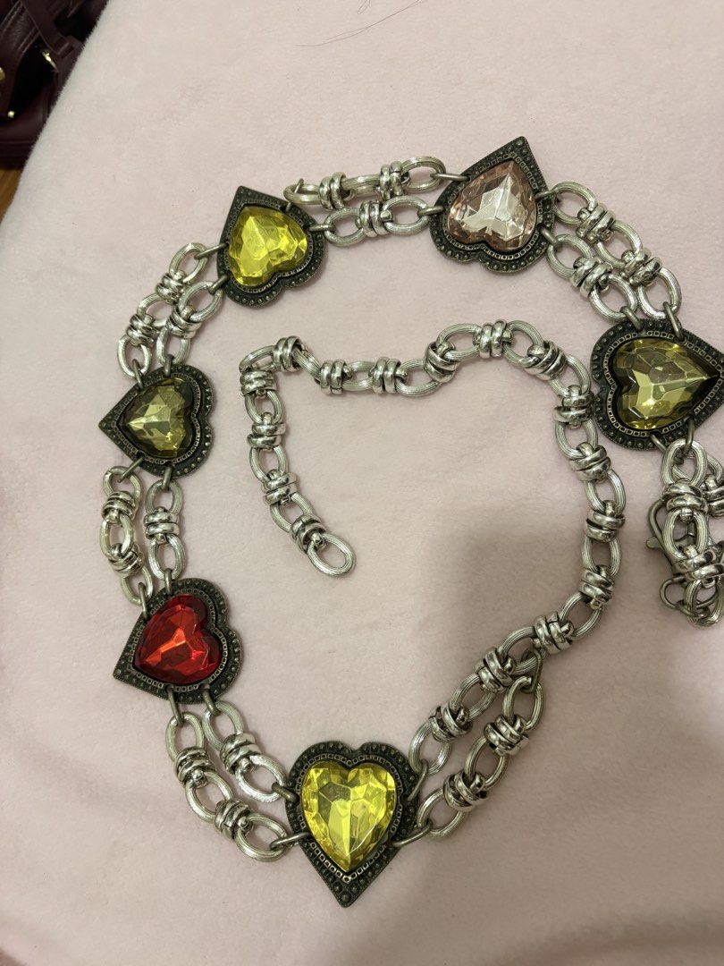 Heart Gem Chain Belt Silver Tone (Category: Belts) located in Iligan City. Submitted by nebulanookph (Listing ID 1462161104, Image 1). Description: - Silver tone chain belt - Double chain design - Heart-shaped gems in red, yellow, and pinkish hues - Clasp closure - Adds color and sparkle to outfits - Versatile for jeans or dresses.